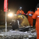 Ground teams recovering the re-entry capsule.